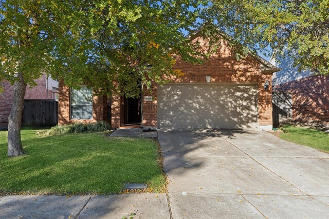 view of front of property with a garage and a front lawn