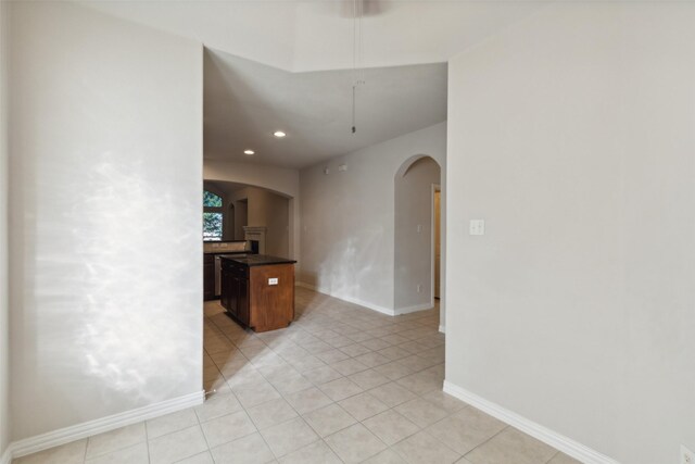 unfurnished living room featuring ceiling fan, light colored carpet, and lofted ceiling