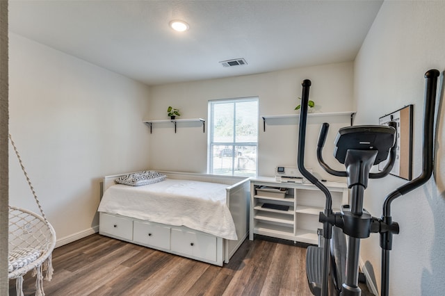 bedroom with dark wood-type flooring