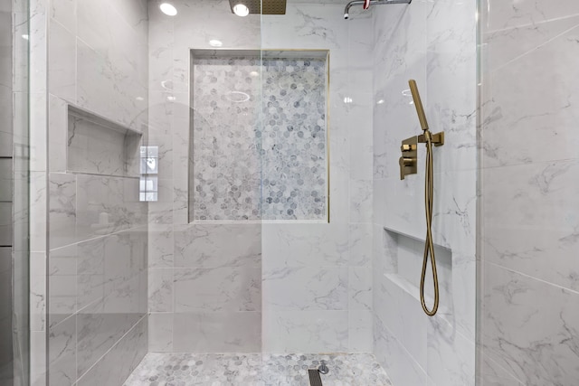 bathroom with a tile shower