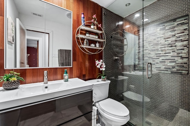 bathroom featuring an enclosed shower, vanity, and toilet