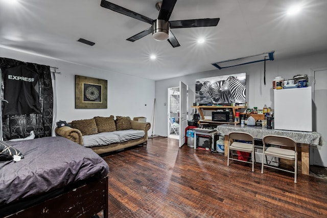 living room featuring a fireplace, dark wood-type flooring, and ceiling fan