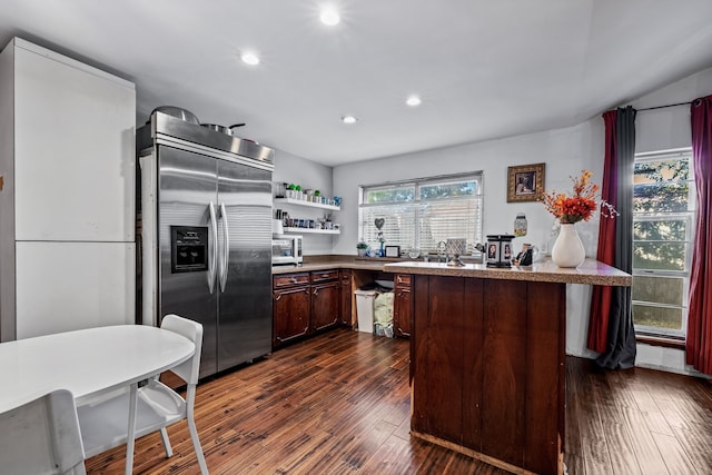 kitchen featuring dark brown cabinetry, dark hardwood / wood-style flooring, and stainless steel appliances