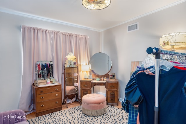 bedroom with light hardwood / wood-style floors and ornamental molding