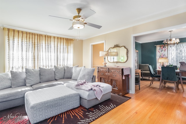 living room featuring hardwood / wood-style flooring, ornamental molding, and a wealth of natural light