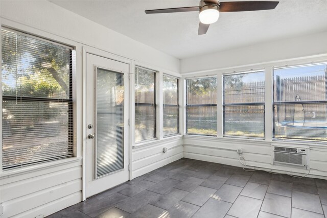 unfurnished sunroom featuring ceiling fan and cooling unit