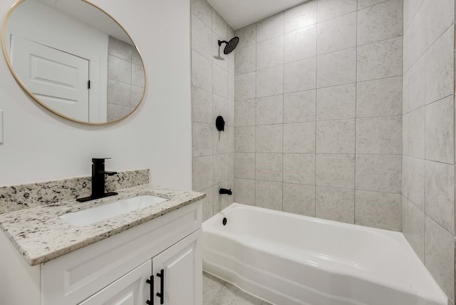 bathroom with vanity, tiled shower / bath combo, and tile patterned floors