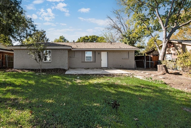 back of property with a patio and a lawn