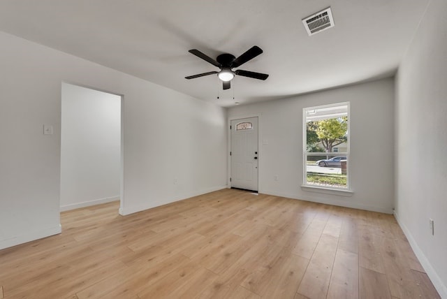 spare room with light wood-type flooring and ceiling fan