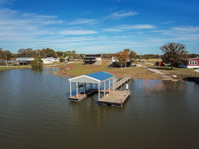 dock area with a yard and a water view