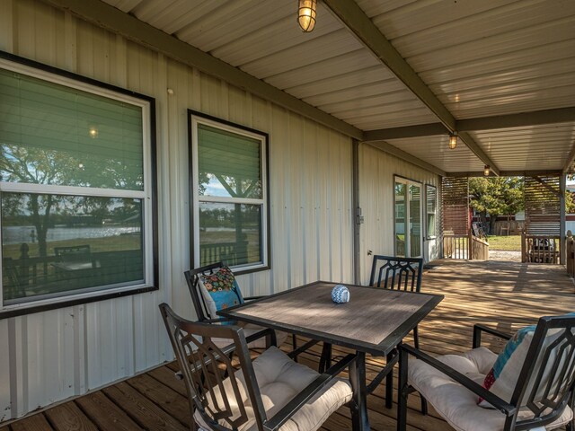 deck with a yard and a water view