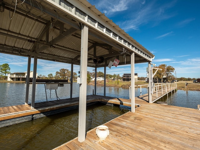 dock area featuring a water view and boat lift
