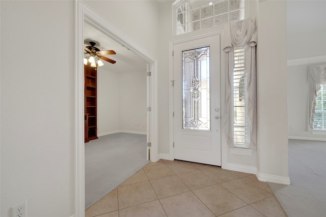 carpeted foyer with ceiling fan