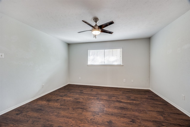 spare room featuring ceiling fan, dark hardwood / wood-style flooring, and a textured ceiling