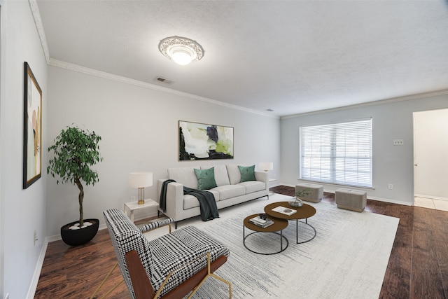 living room with dark wood-type flooring, a textured ceiling, and ornamental molding