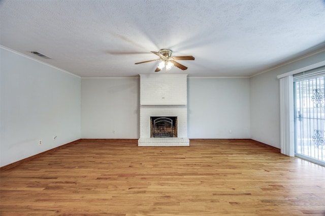 unfurnished living room with a fireplace, light hardwood / wood-style floors, and a textured ceiling