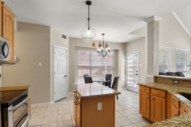 kitchen with stainless steel appliances, light tile patterned floors, a kitchen island, pendant lighting, and a notable chandelier