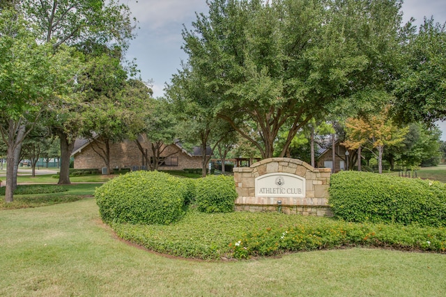 community sign featuring a lawn