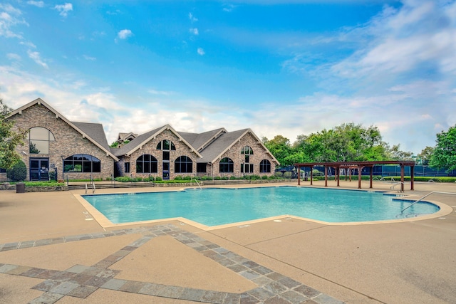 view of swimming pool with a patio