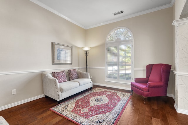 sitting room with ornamental molding and dark hardwood / wood-style floors