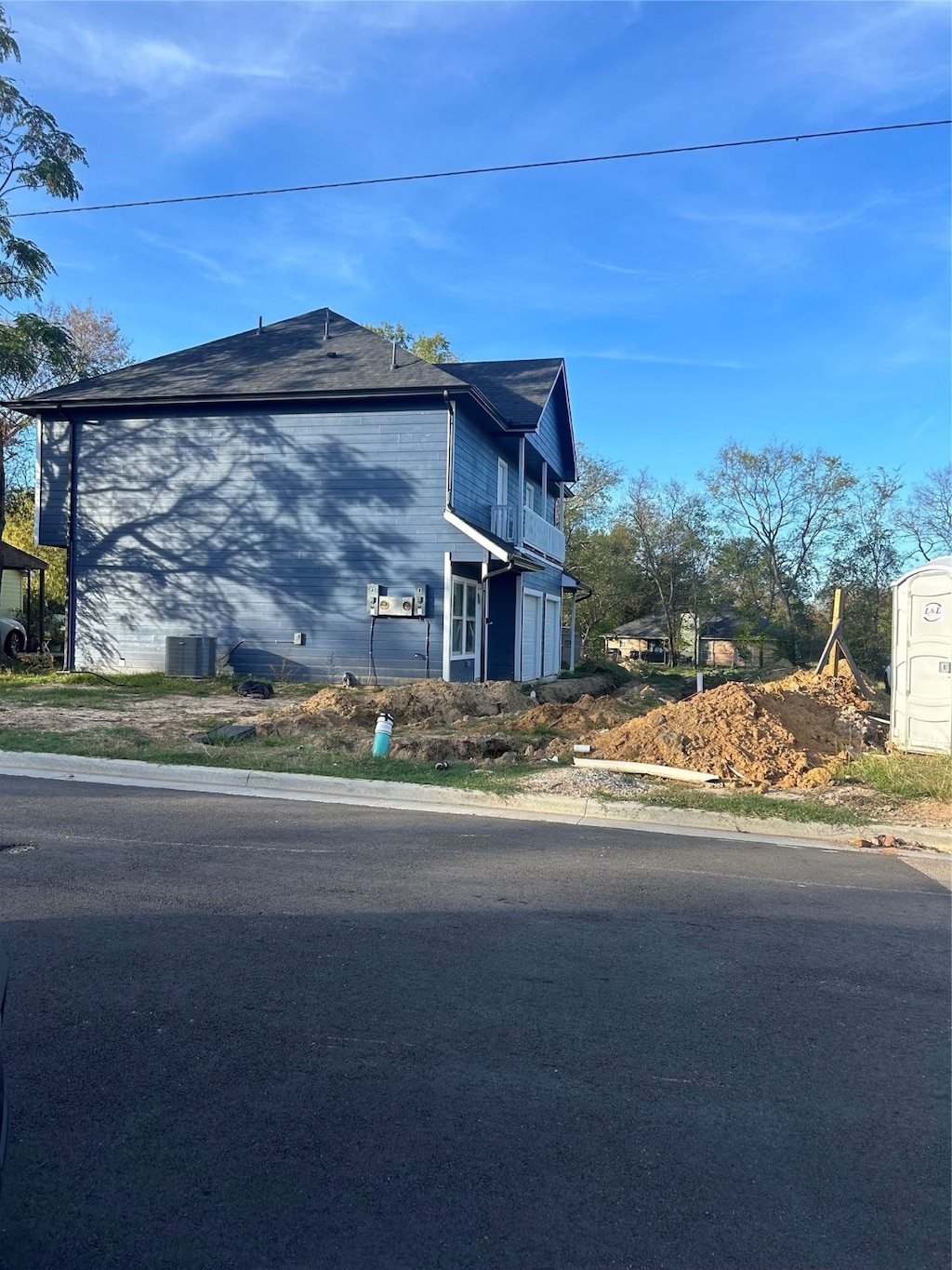 view of side of property with central AC unit