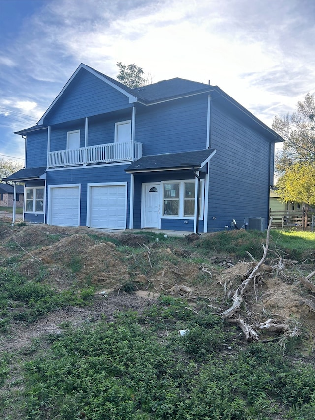 view of front property featuring a balcony and central air condition unit