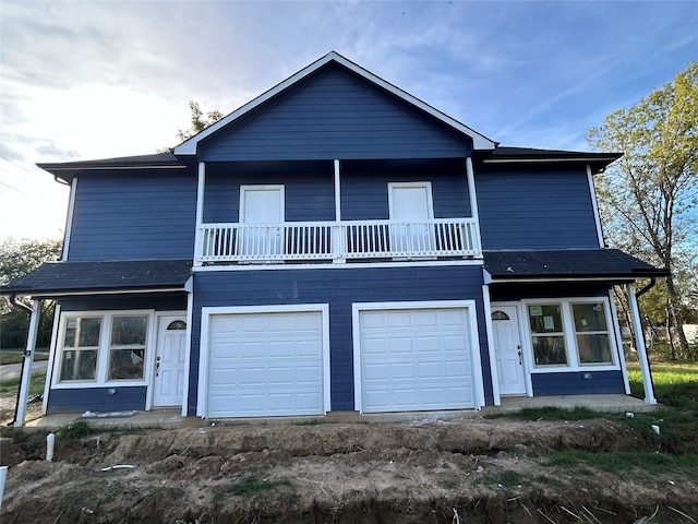 view of front property featuring a balcony and a garage