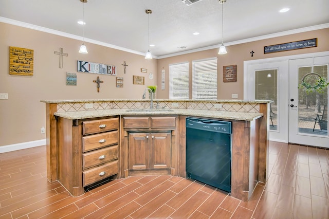 kitchen with dishwasher, sink, light hardwood / wood-style floors, pendant lighting, and a kitchen island