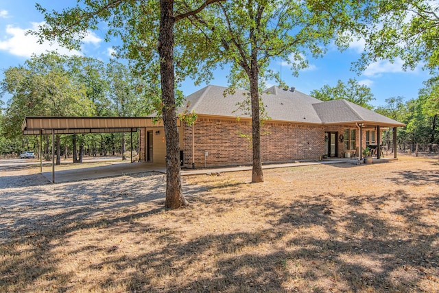 rear view of property featuring a carport