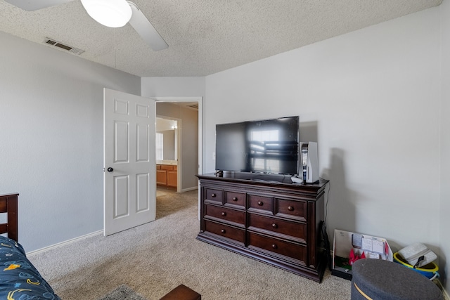 bedroom featuring ceiling fan, light carpet, and a textured ceiling