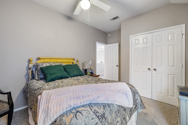 carpeted bedroom featuring a textured ceiling, ceiling fan, a closet, and lofted ceiling