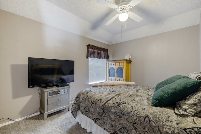 carpeted bedroom with ceiling fan, a textured ceiling, and vaulted ceiling