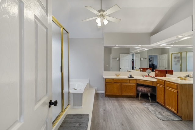 bathroom with vanity, vaulted ceiling, hardwood / wood-style flooring, ceiling fan, and independent shower and bath