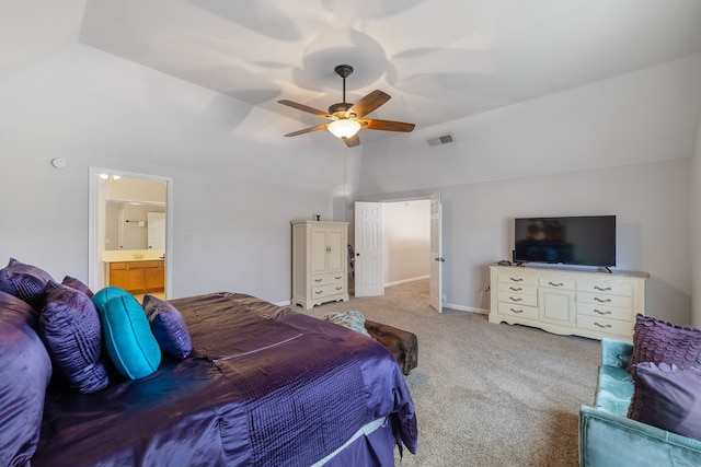 bedroom with connected bathroom, light colored carpet, and ceiling fan