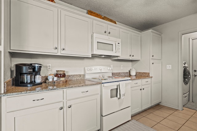 kitchen featuring a textured ceiling, white cabinets, and white appliances