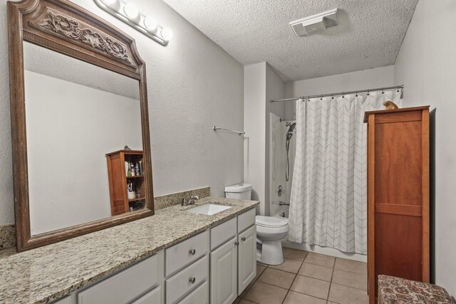 full bathroom with shower / bath combo, tile patterned floors, a textured ceiling, toilet, and vanity