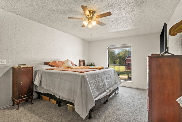 carpeted bedroom with a textured ceiling and ceiling fan