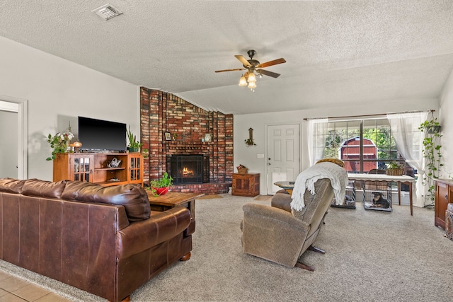 carpeted living room with a fireplace, a textured ceiling, ceiling fan, and lofted ceiling