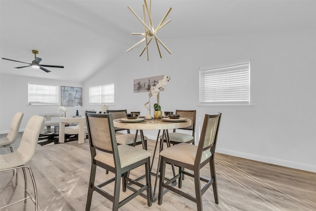 dining area featuring ceiling fan, light hardwood / wood-style floors, and vaulted ceiling