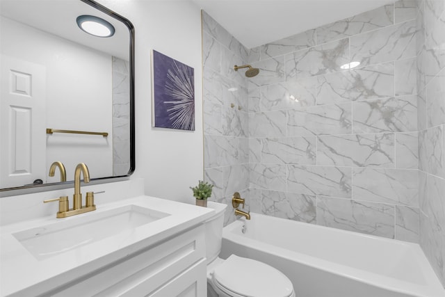 full bathroom featuring tiled shower / bath, vanity, and toilet