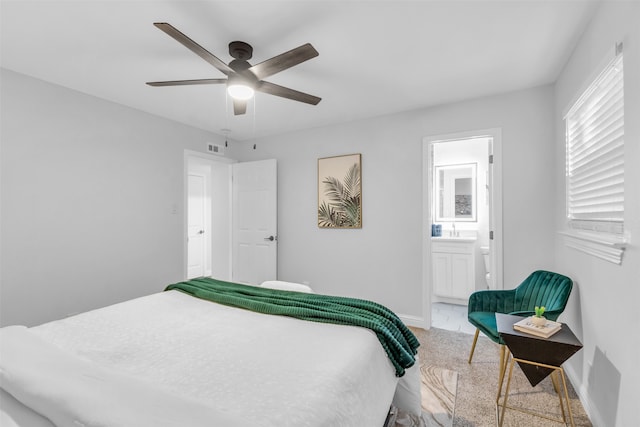 carpeted bedroom featuring ensuite bathroom and ceiling fan