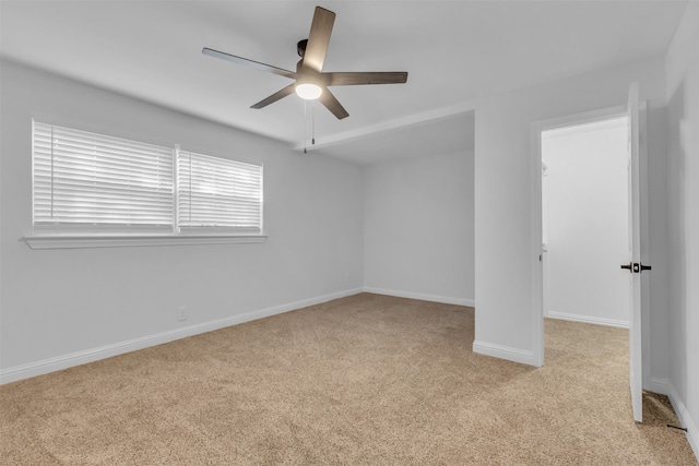 spare room featuring light carpet and ceiling fan