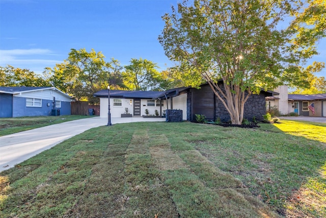 single story home with central AC unit and a front yard