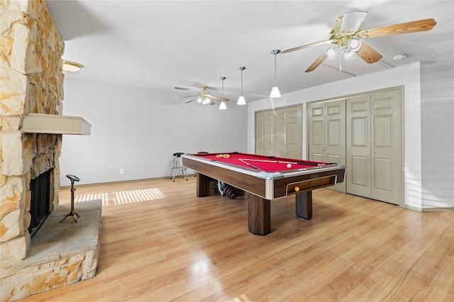 game room with ceiling fan, light hardwood / wood-style floors, a fireplace, and pool table