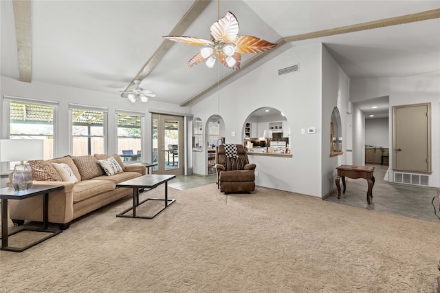 carpeted living room with beamed ceiling, ceiling fan, and high vaulted ceiling