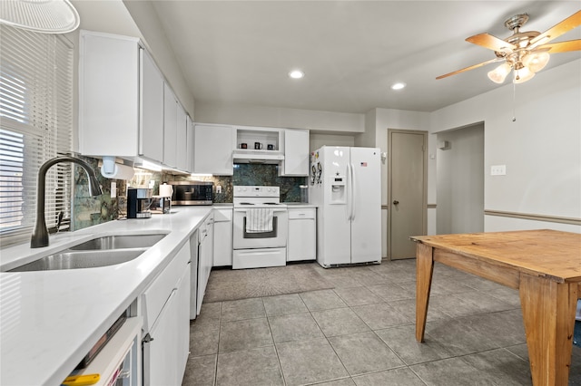 kitchen featuring backsplash, white appliances, sink, white cabinetry, and light tile patterned flooring