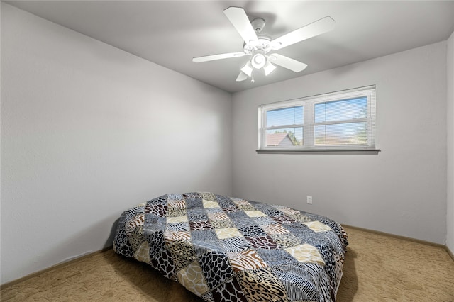 bedroom featuring light carpet and ceiling fan