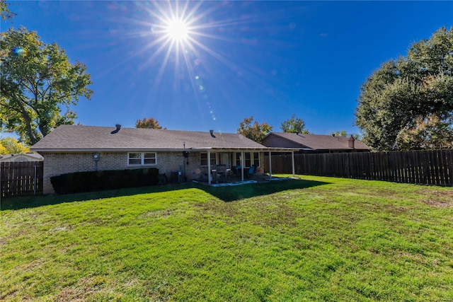 back of property featuring a lawn