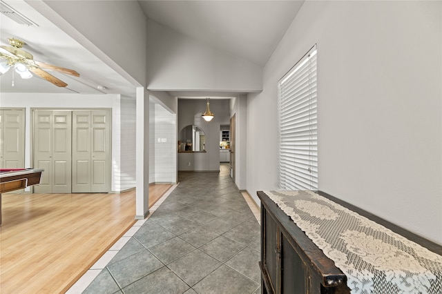 corridor featuring hardwood / wood-style flooring and lofted ceiling