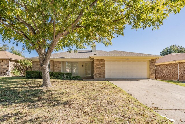 ranch-style home featuring a garage